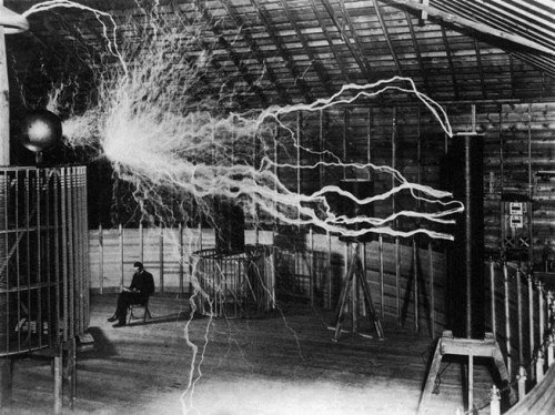 Nikola Tesla conducting his famous high voltage experiments in his lab.